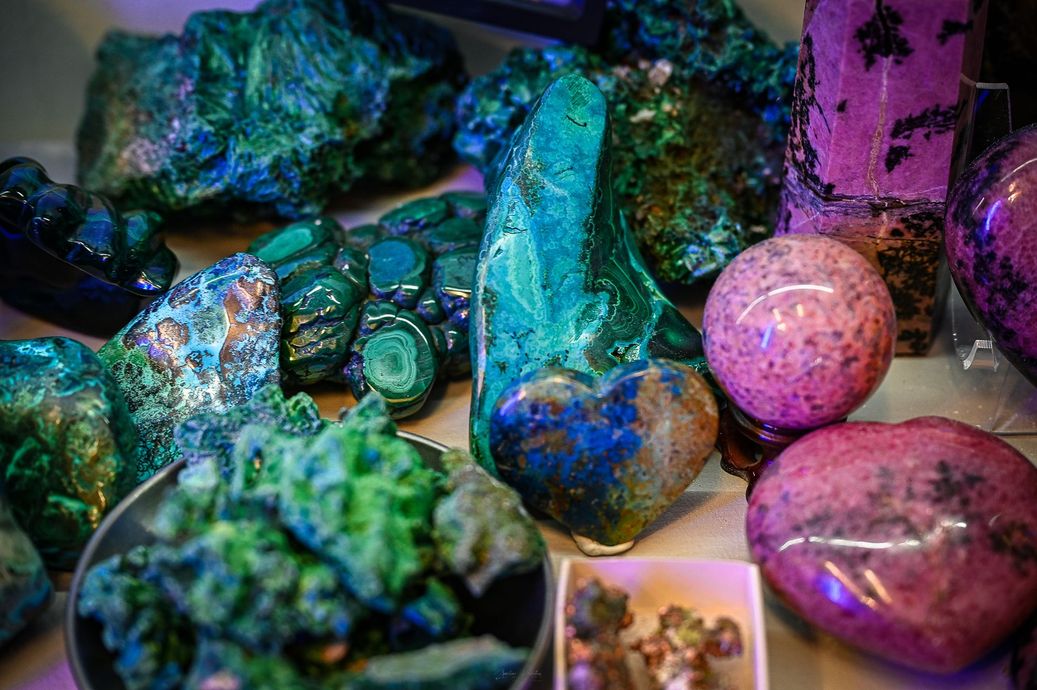 There are many different types of rocks and crystals on the table.