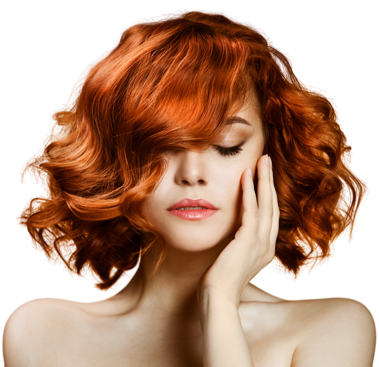 A woman with red hair is covering her face with her hand.