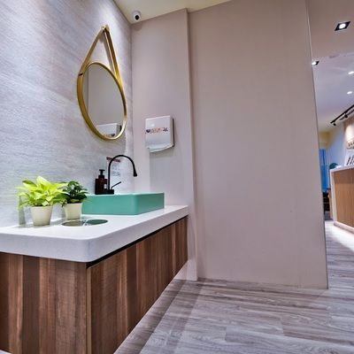 A bathroom with a sink and a mirror on the wall