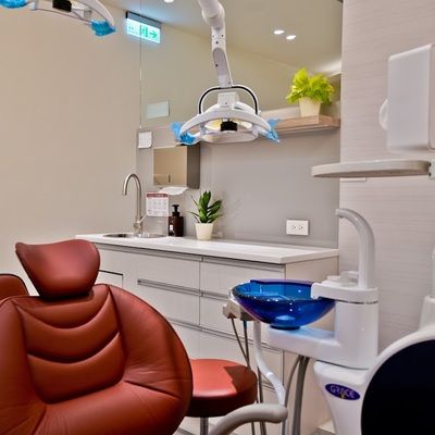 A dental office with a dental chair and a sink