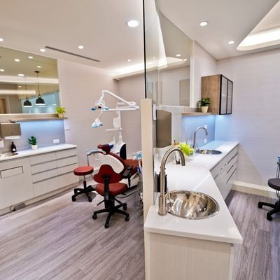 A dental office with a sink and a chair