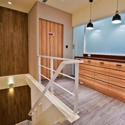 A staircase with a white railing and a wooden door