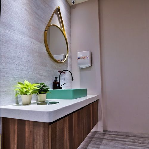 A bathroom with a sink and a mirror on the wall