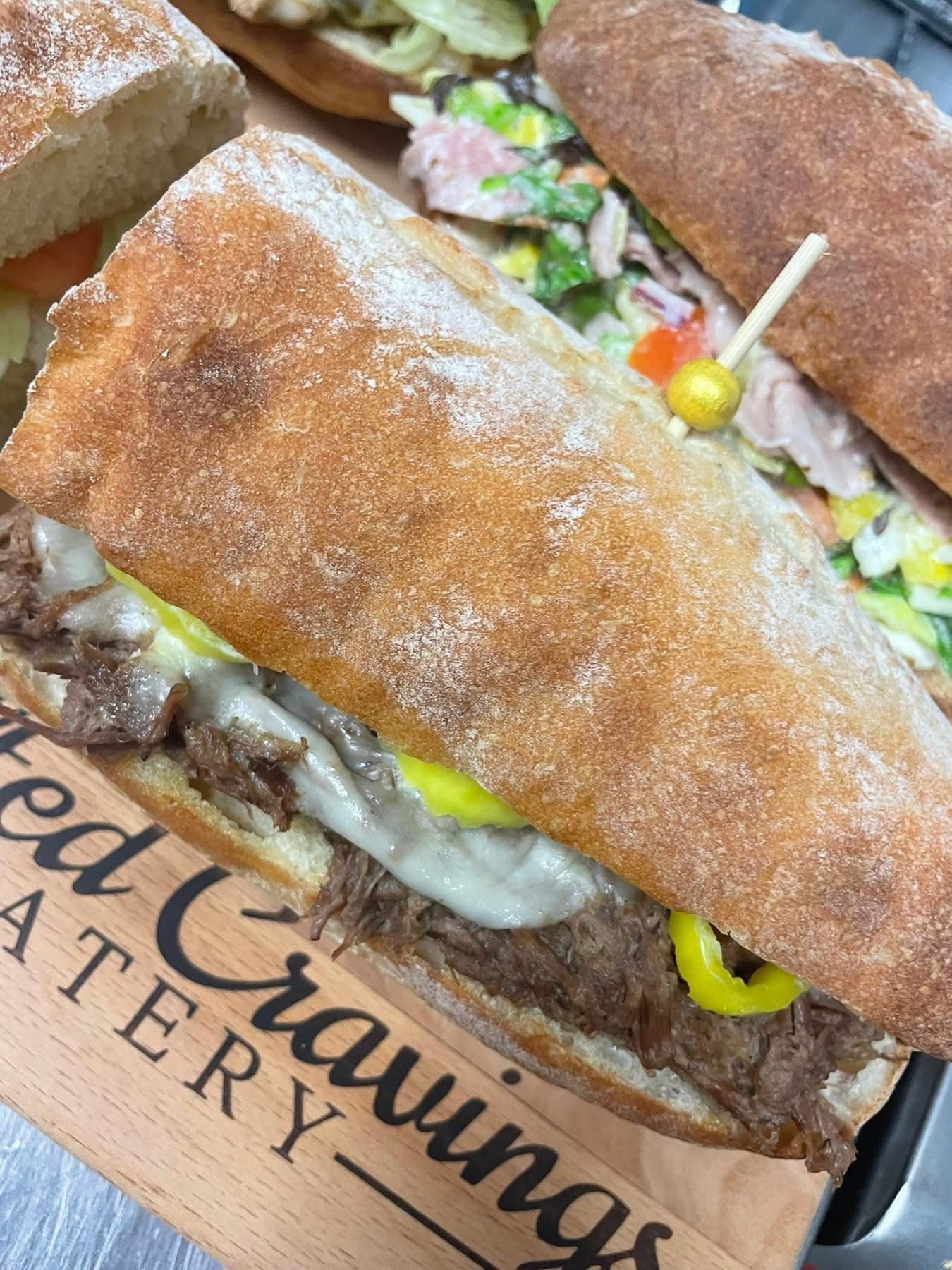 Skewered appetizers: salami roses, cheese cubes, olives, and pepperoni on a platter.