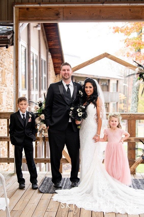Person pulling apart a grilled cheese sandwich with gooey, melted cheese.
