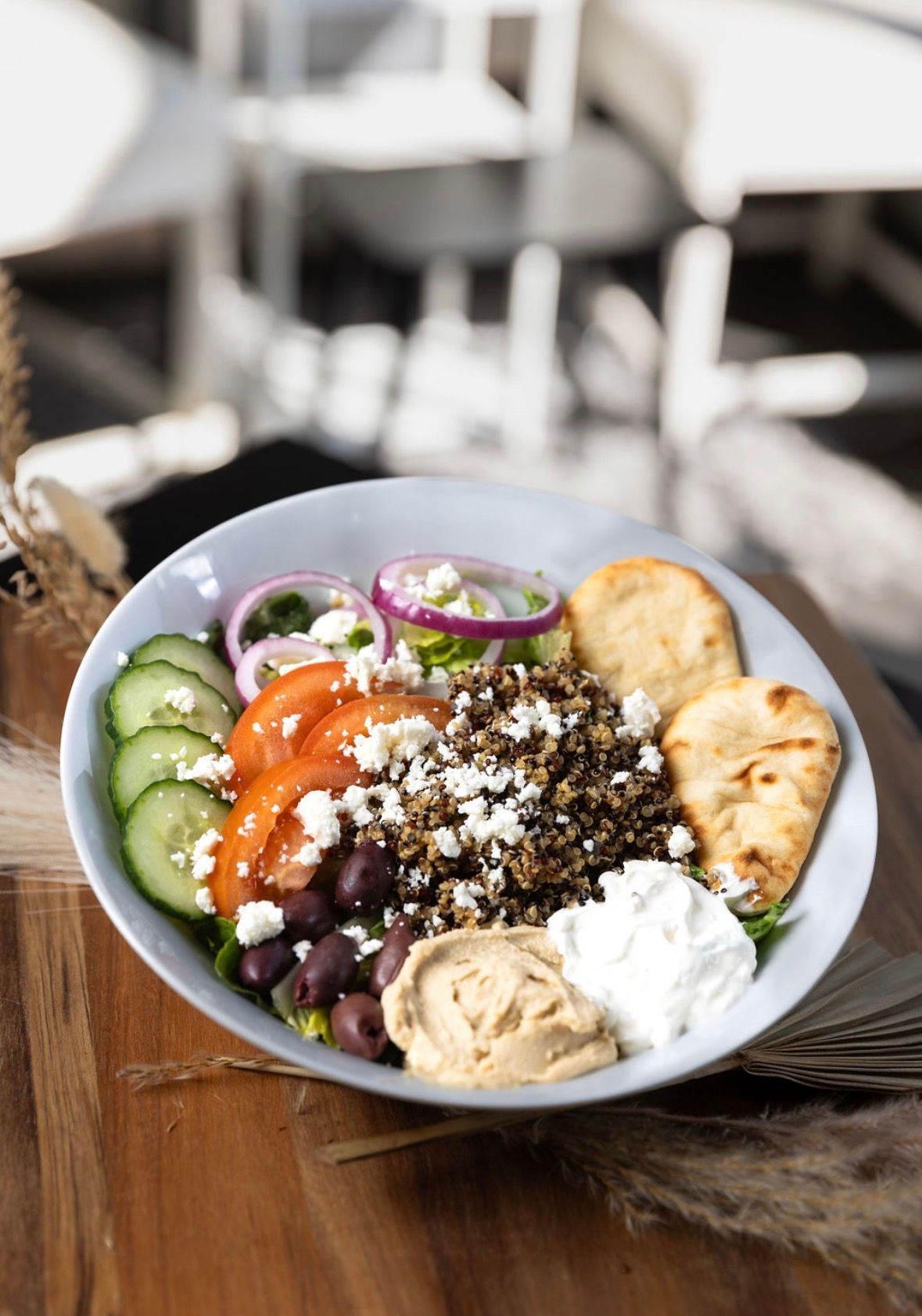 Person pulling apart a grilled cheese sandwich with gooey, melted cheese.