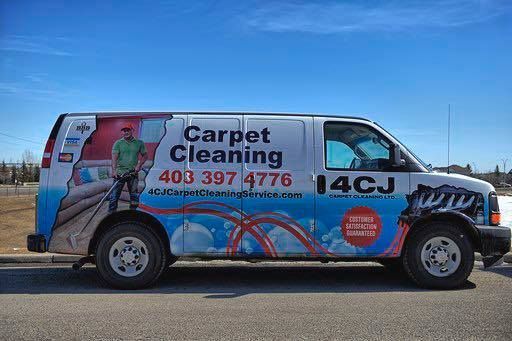 A carpet cleaning van is parked on the side of the road.