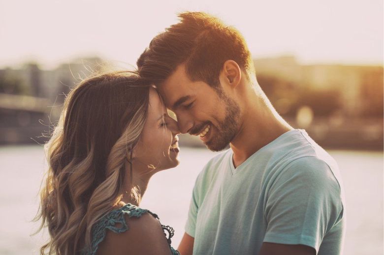 A man and a woman are looking into each other 's eyes.
