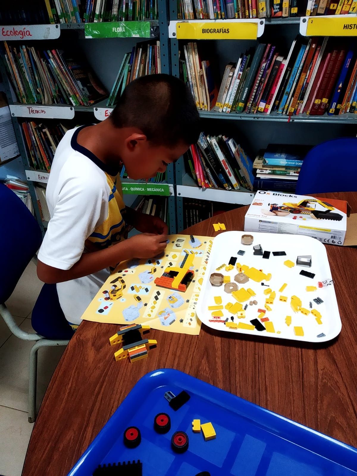 A young boy student working with Legos. 