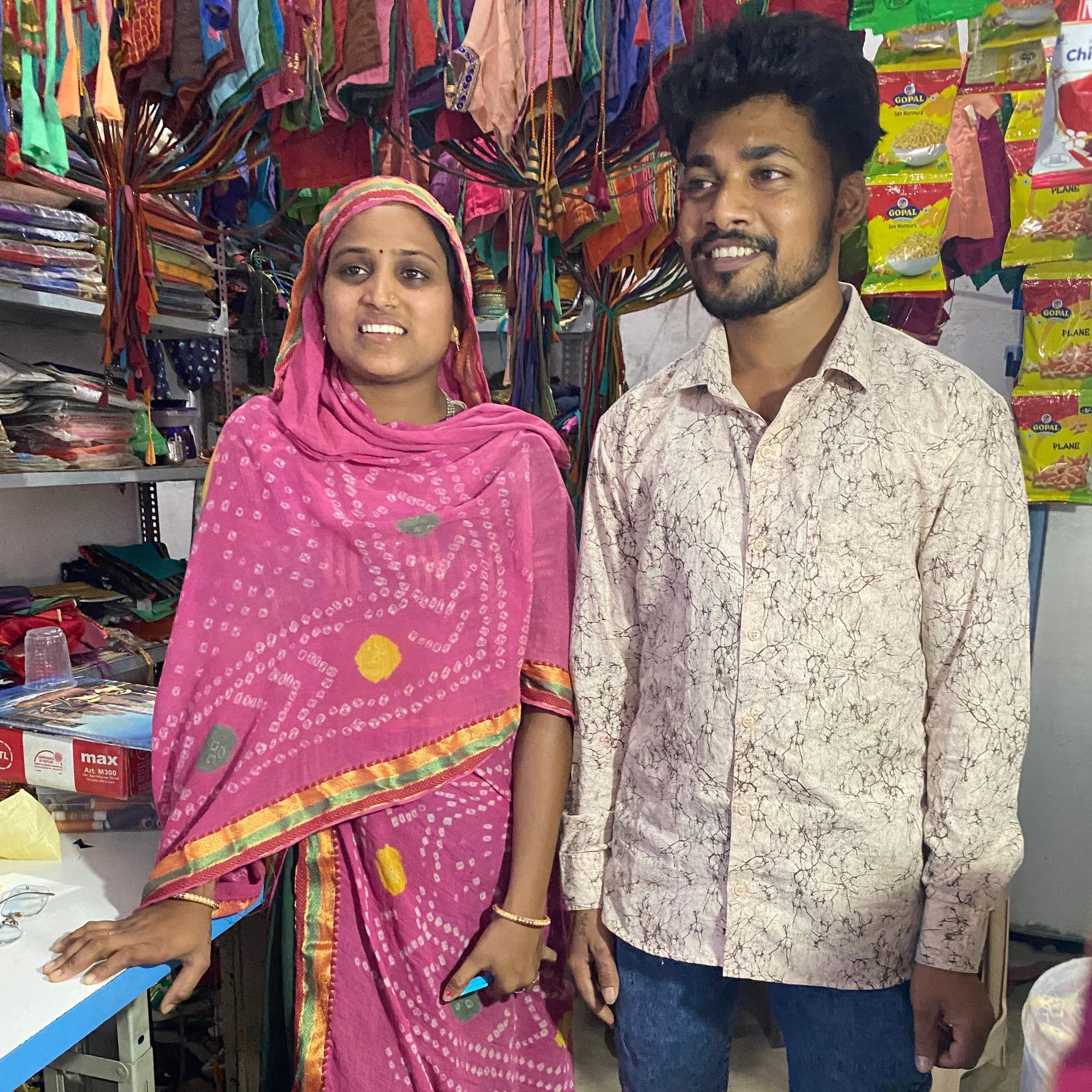 portrait of couple standing in their taoiloring shop