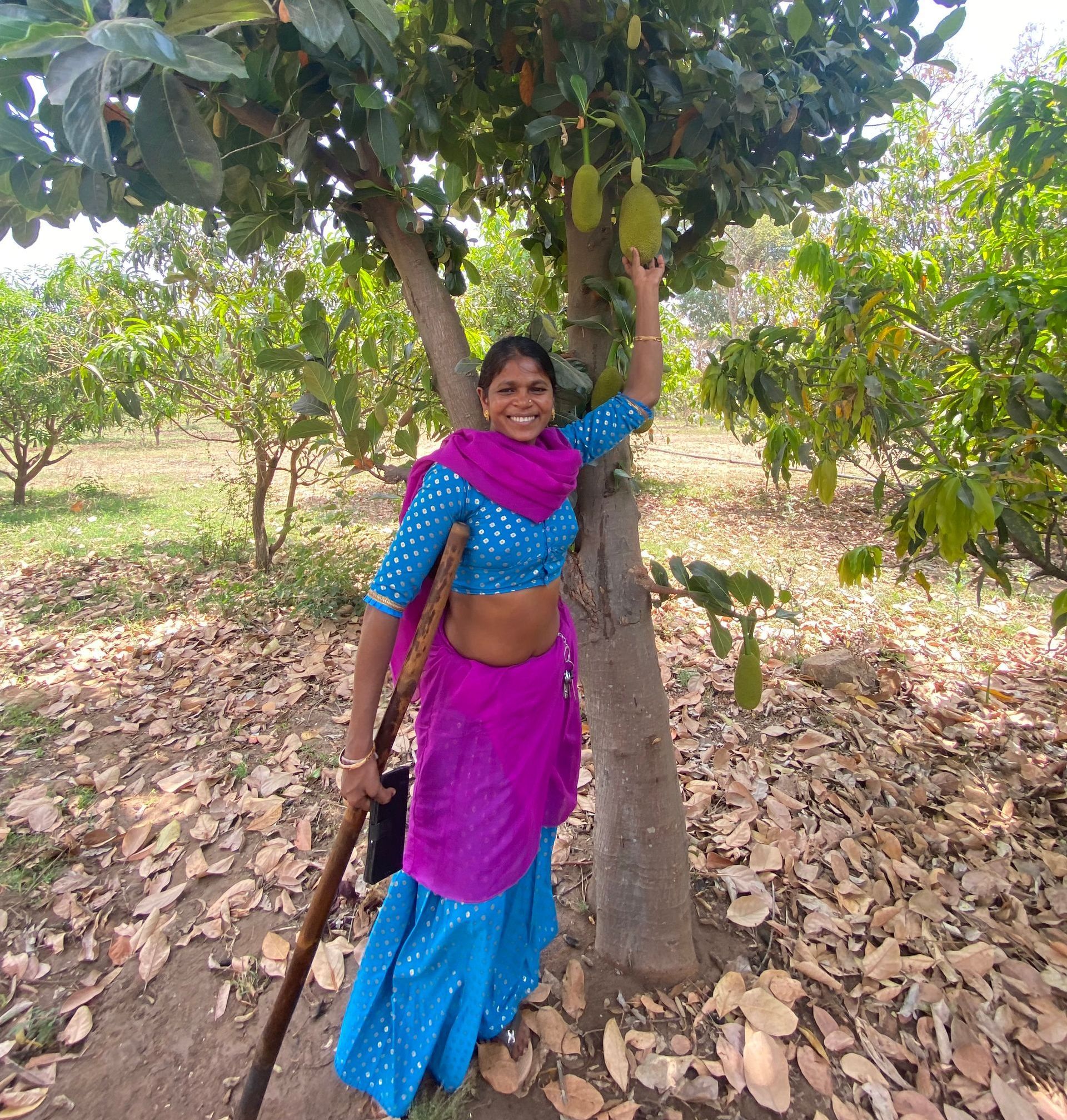 Portrait of Kali next to a fruit producing tree