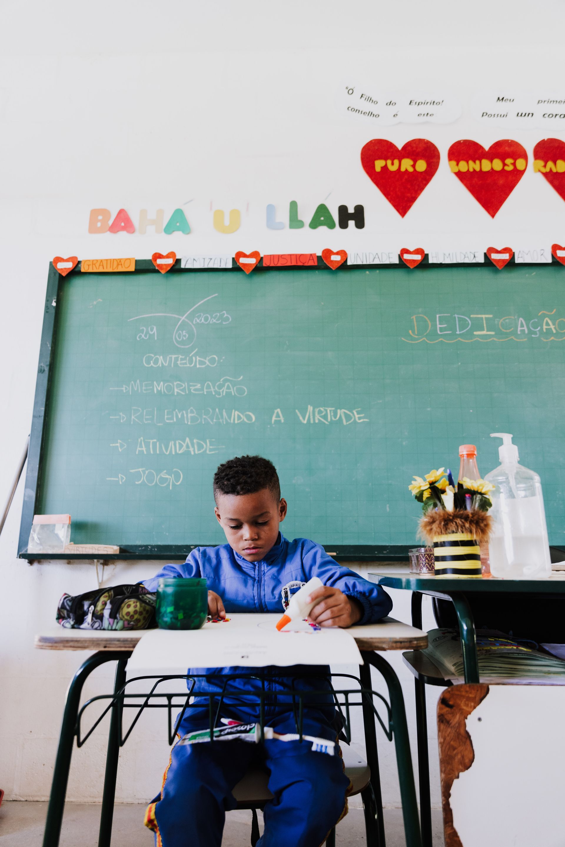 A young boy student focused and learning in the classroom. 