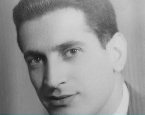 A black and white photo of a young man in a suit and tie.