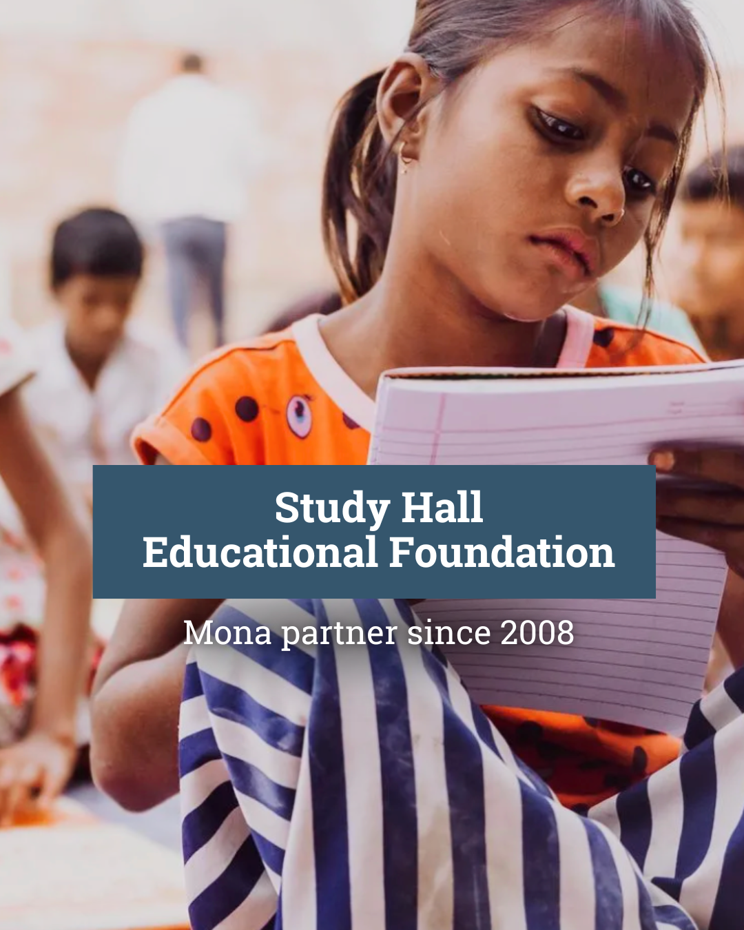 A teacher is talking to a group of children in a classroom.