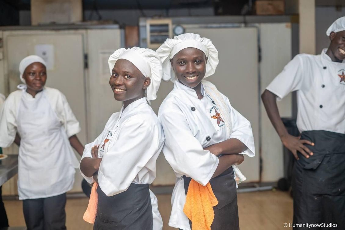 A group of chefs are posing for a picture with their arms crossed