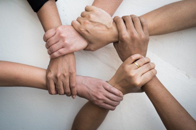 Stock photo of people linking arms. 