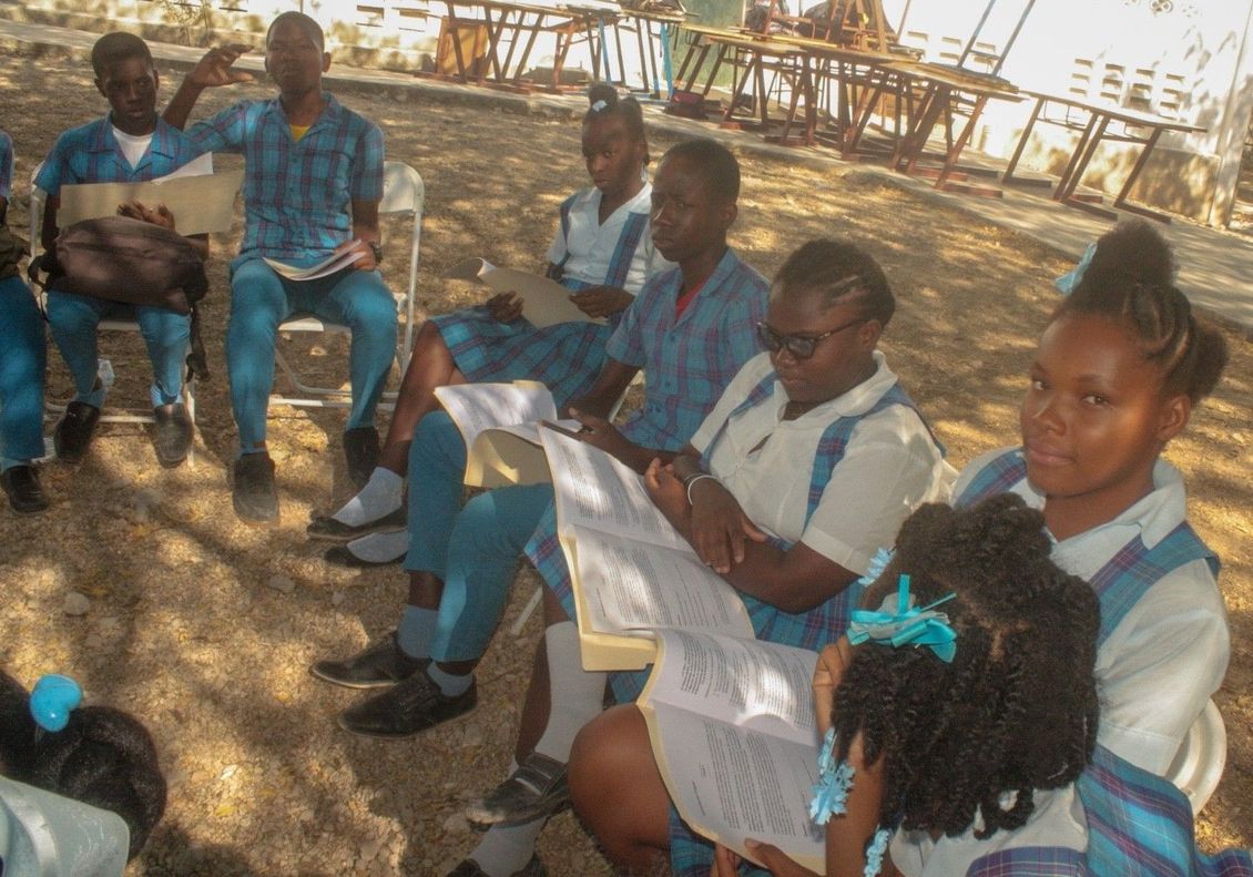 A group of children are sitting in a circle reading books