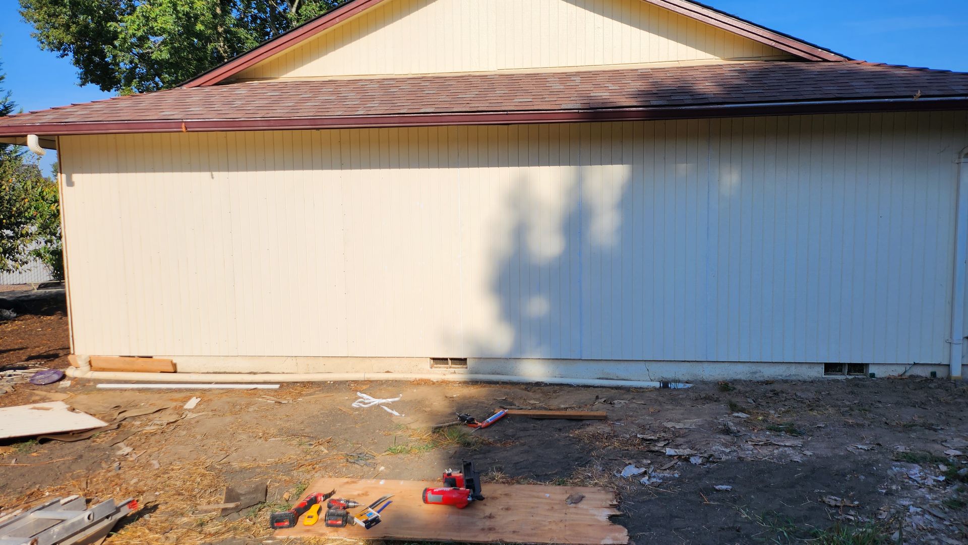 A garage door is being installed on the side of a house.