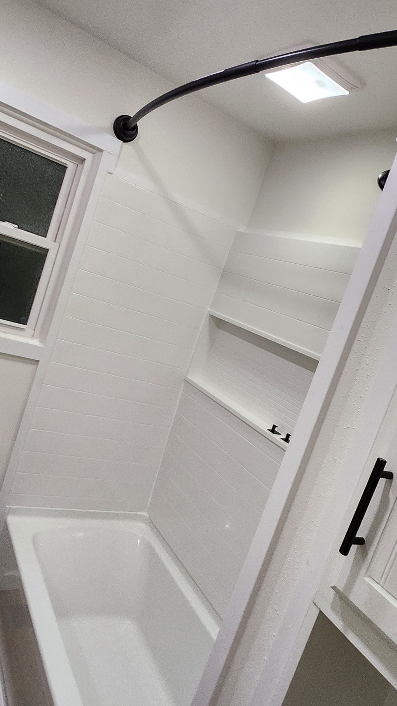 A bathroom with a bathtub and a shower.