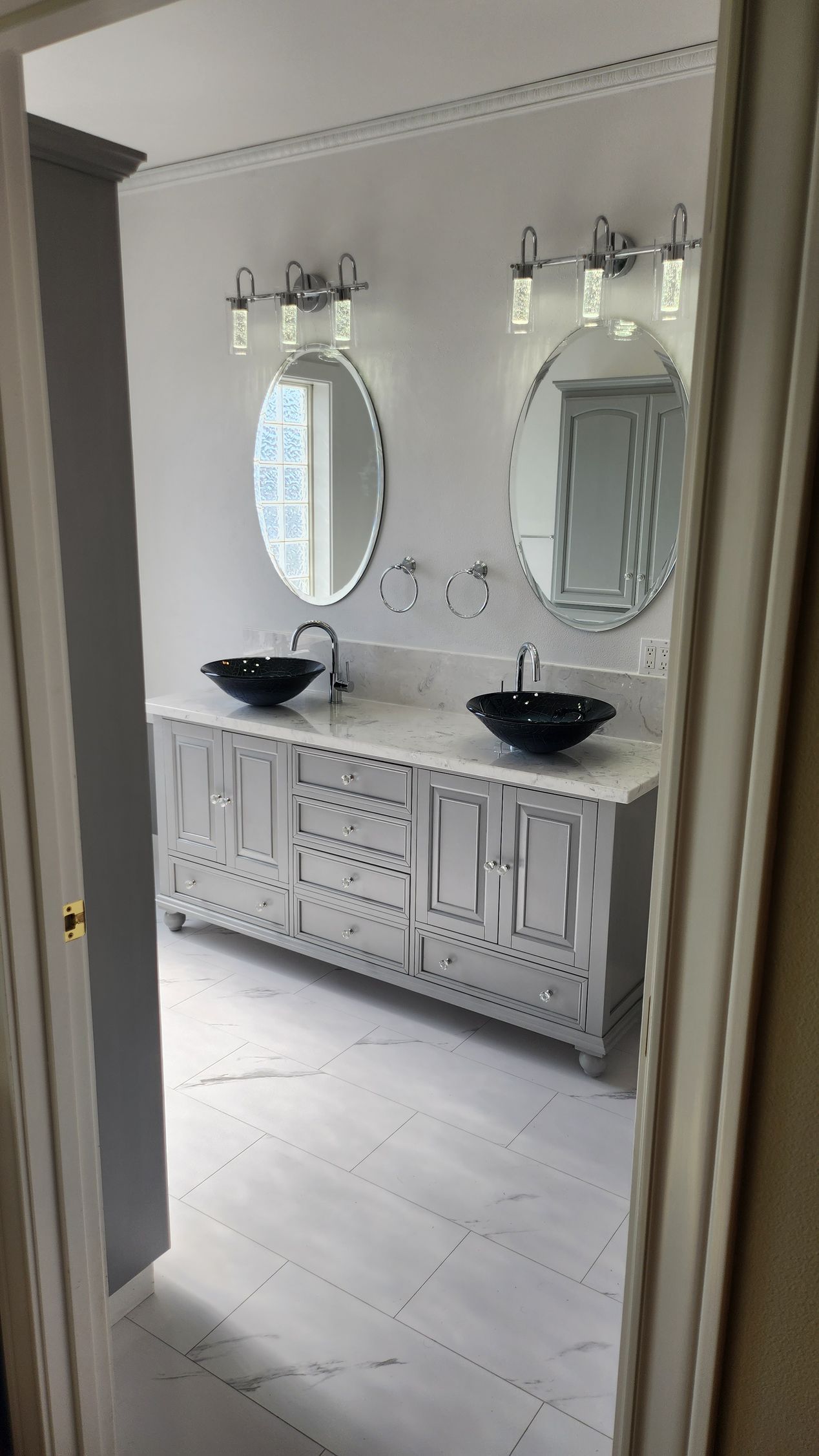 A bathroom with two sinks and two mirrors.
