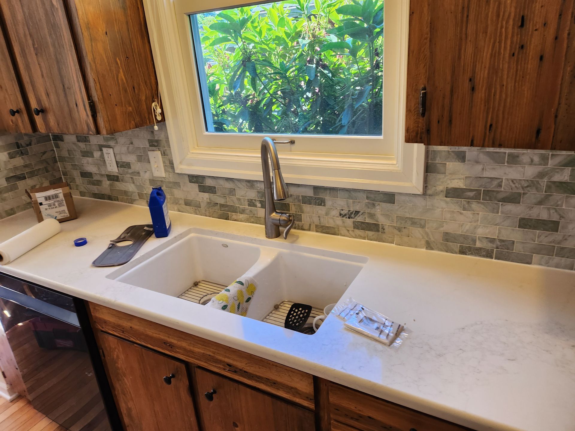 A kitchen with a double sink and a window.