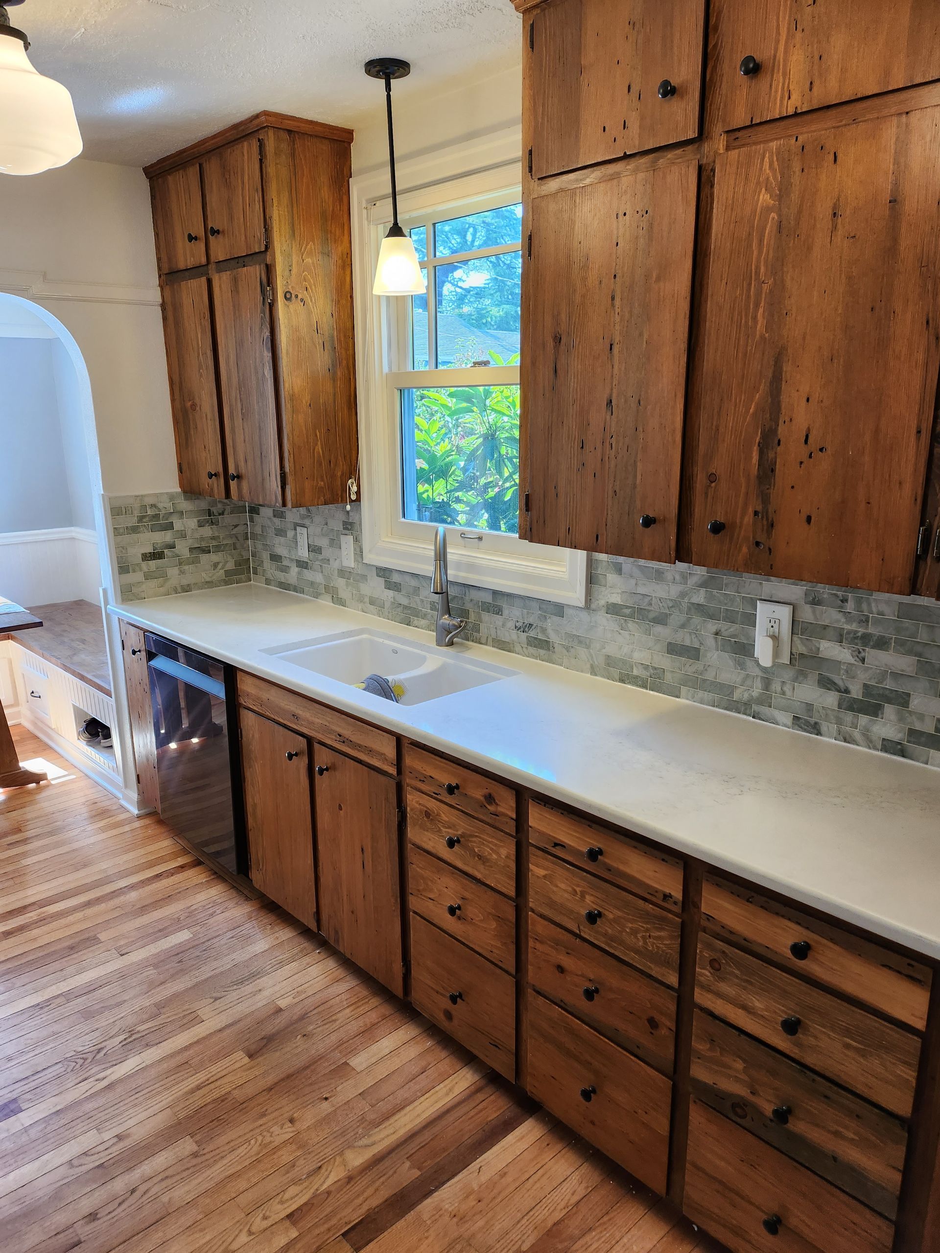 A kitchen with wooden cabinets and a sink