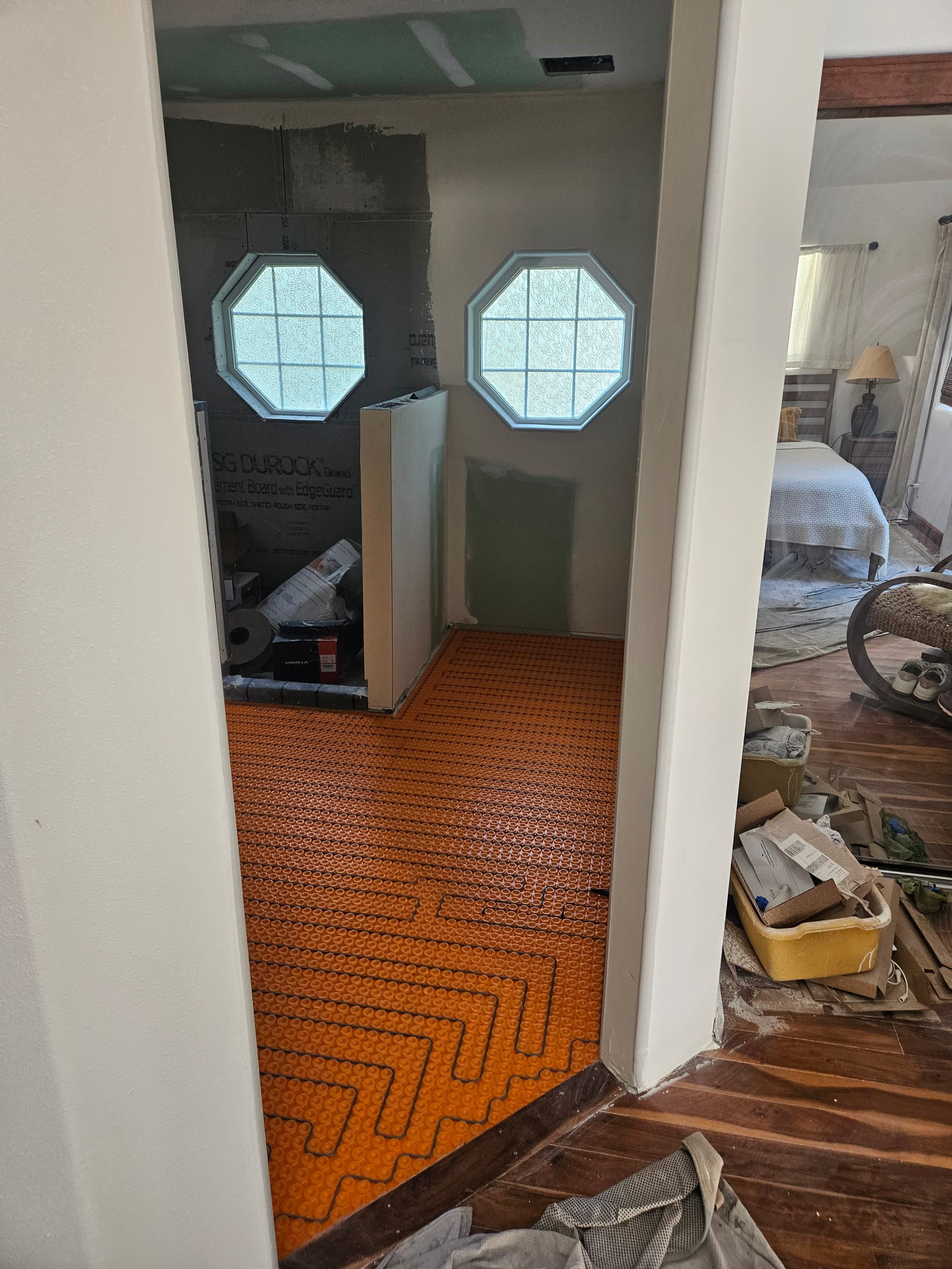 A hallway leading to a bedroom with a window.