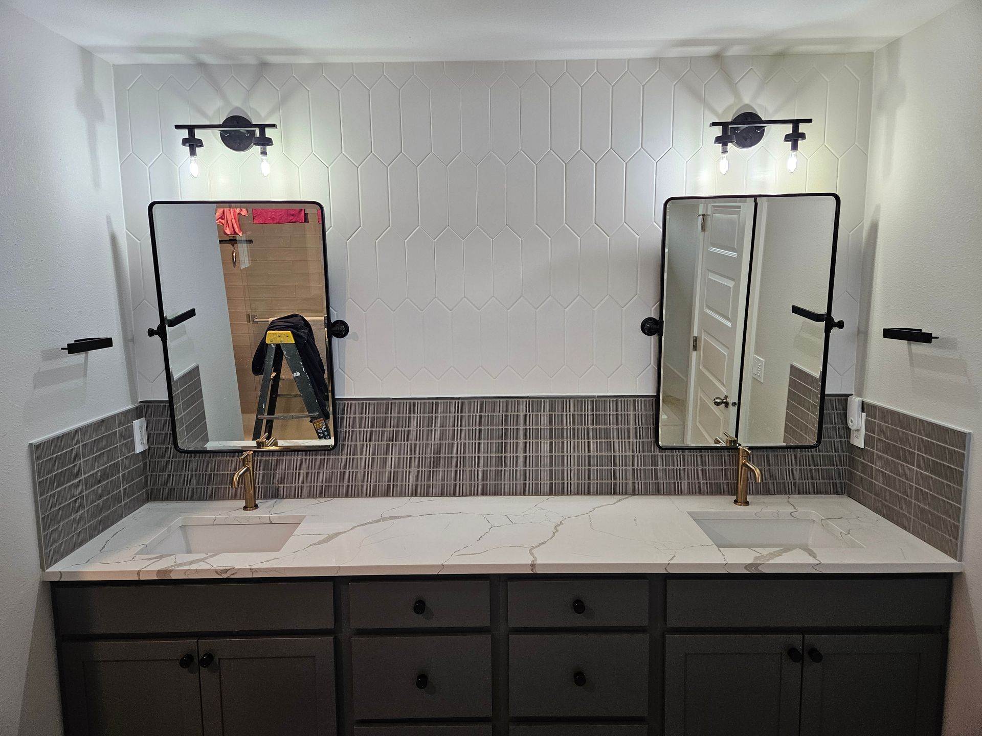 A bathroom with two sinks and two mirrors.
