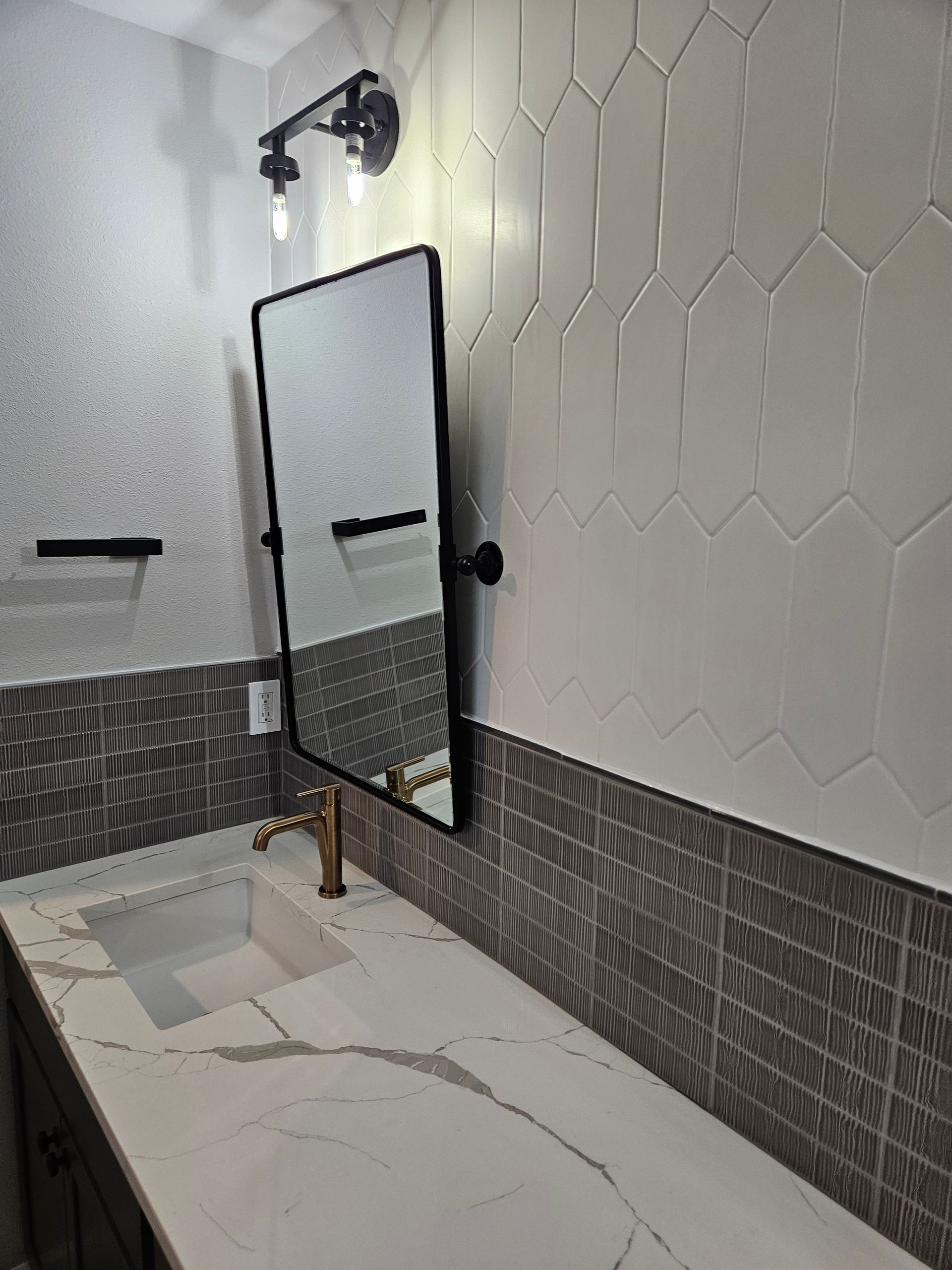 A bathroom with a sink and a mirror on the wall.