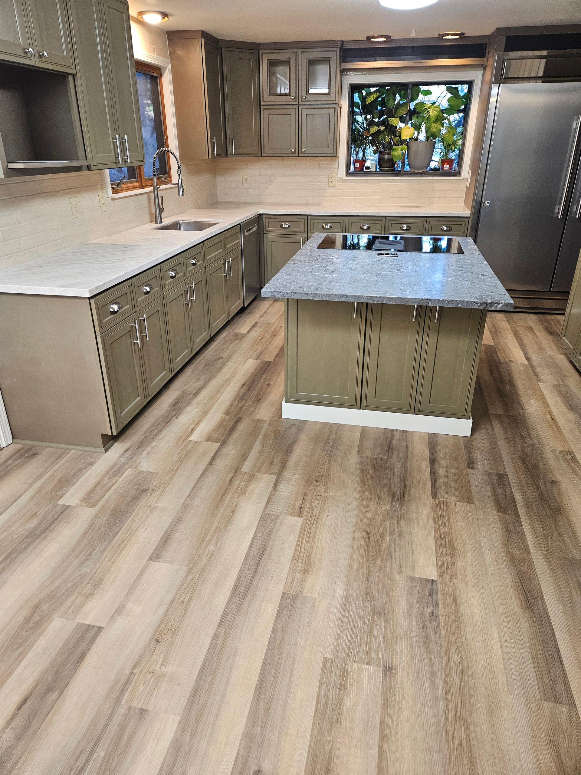 A kitchen with a large island in the middle of it.