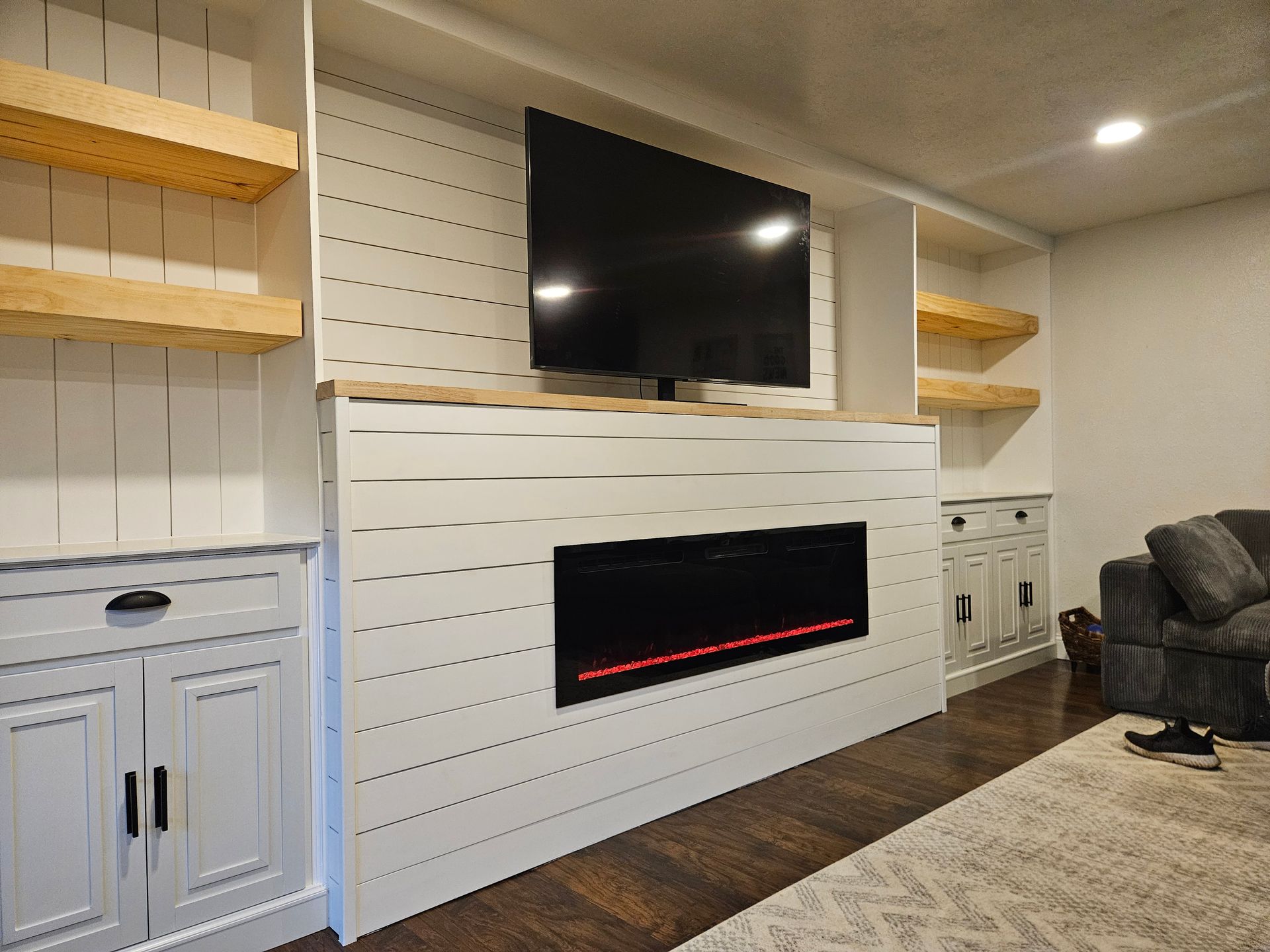 A living room with a fireplace and a flat screen tv.
