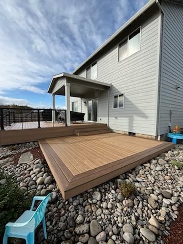 A large house with a wooden deck in front of it.