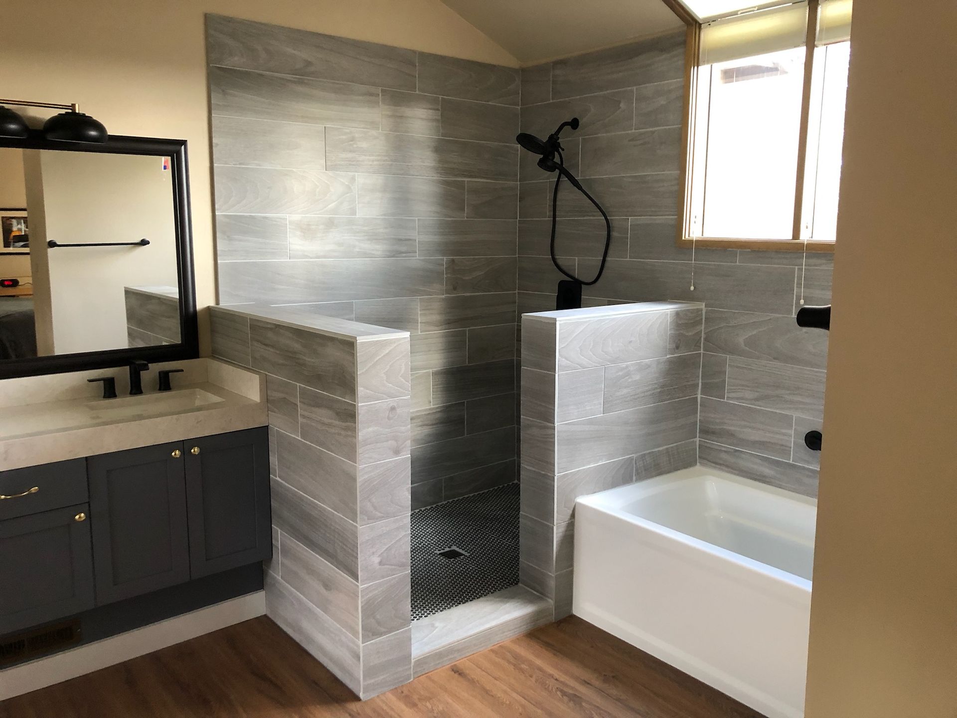 A bathroom with a walk in shower and a bathtub.