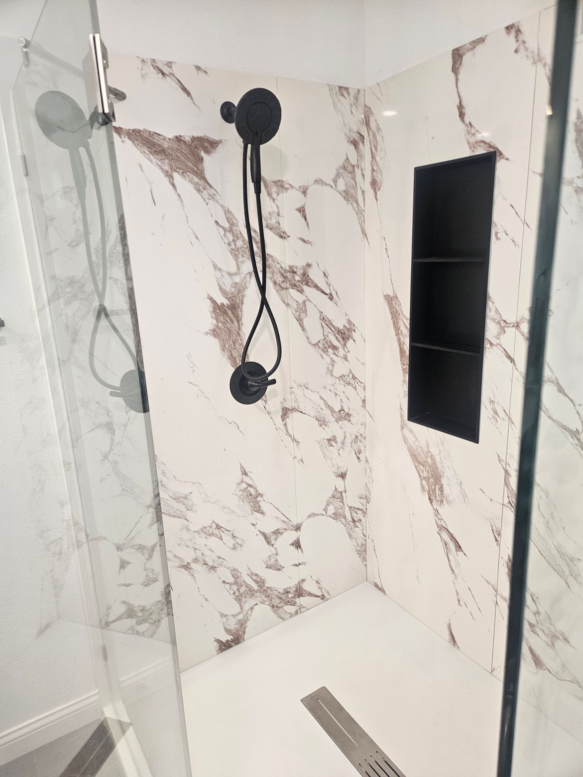 A bathroom with a walk in shower and a toilet.