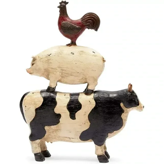 A rooster is sitting on top of a cow and a pig