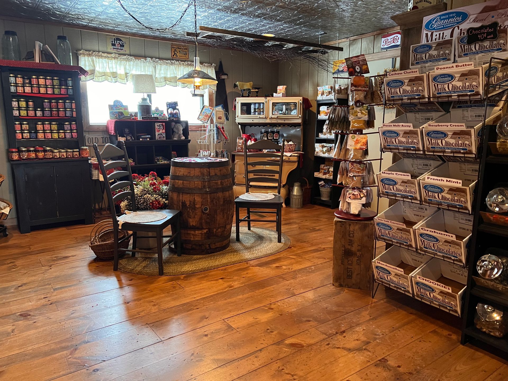 There is a barrel in the middle of the room in a store.