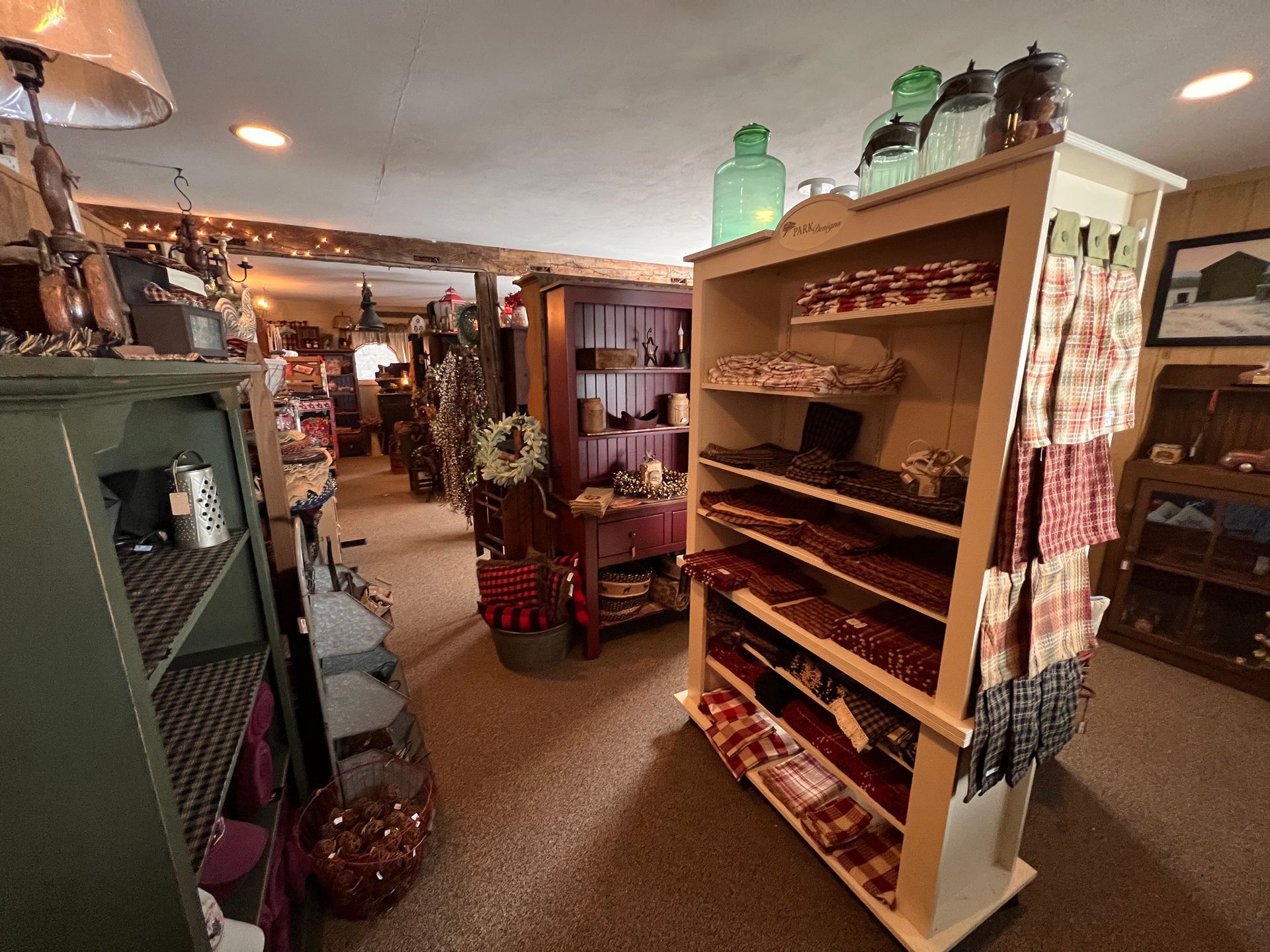 A room with a lot of shelves and a picture on the wall