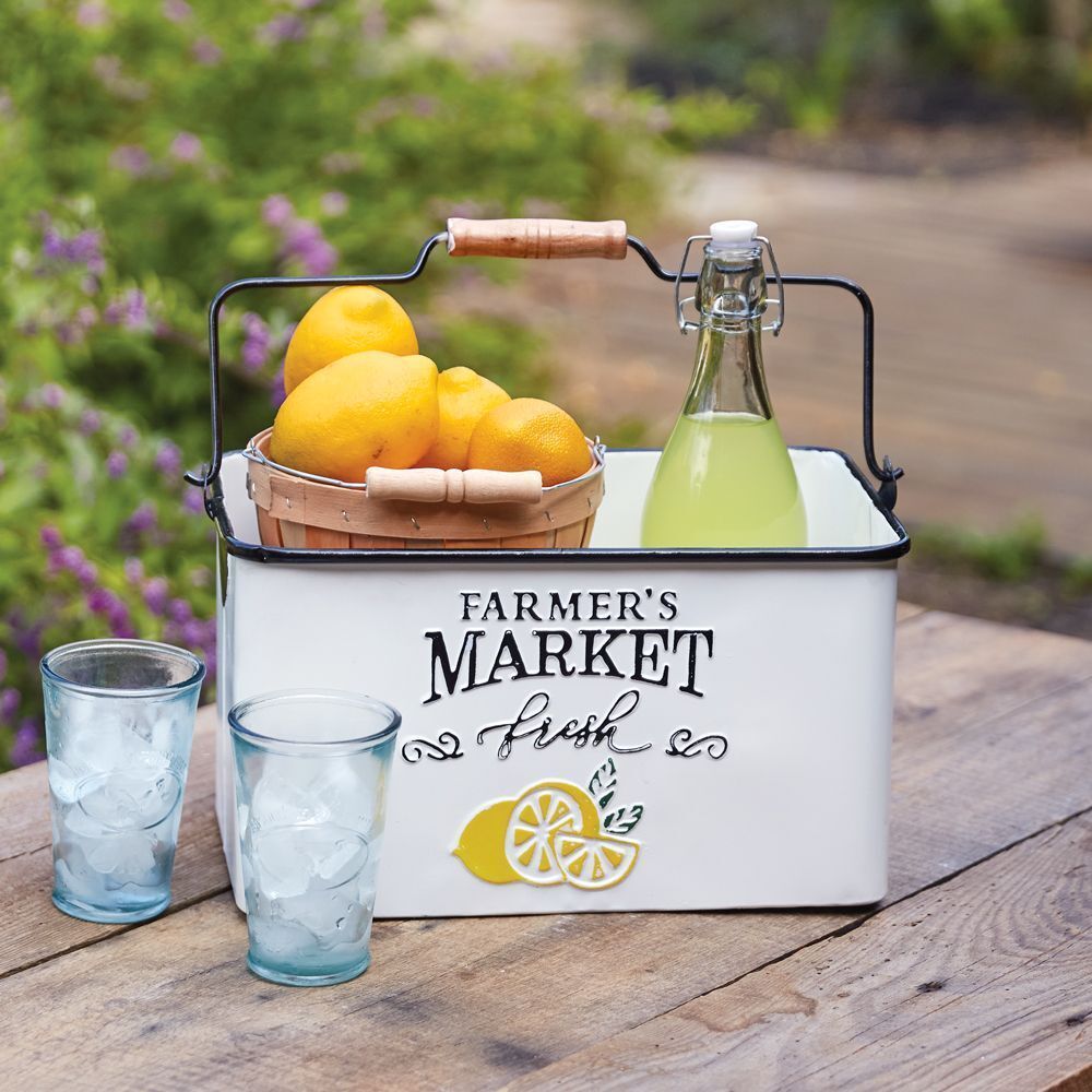 A farmer 's market cooler with a basket of lemons and a bottle of lemonade