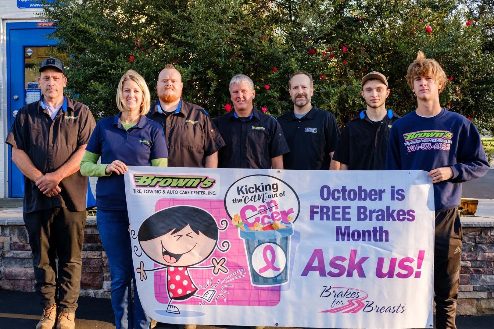 Group of people holding a banner for 