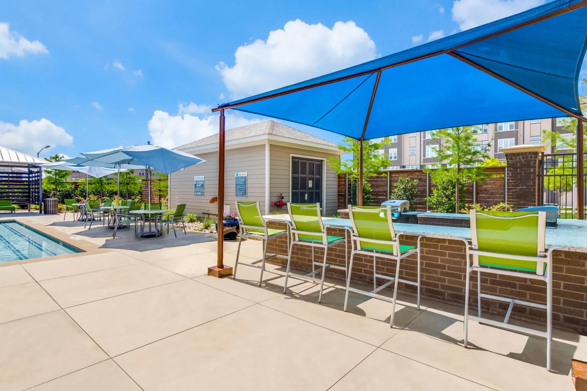 Poolside lounge area at Harmony Luxury Apartments in Rowlett, TX.