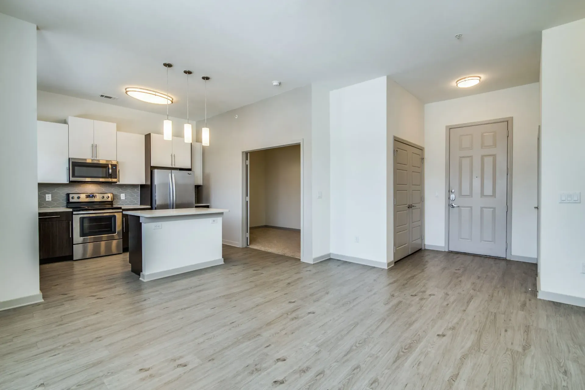 Kitchen and living area at Harmony Luxury Apartments in Rowlett, TX.