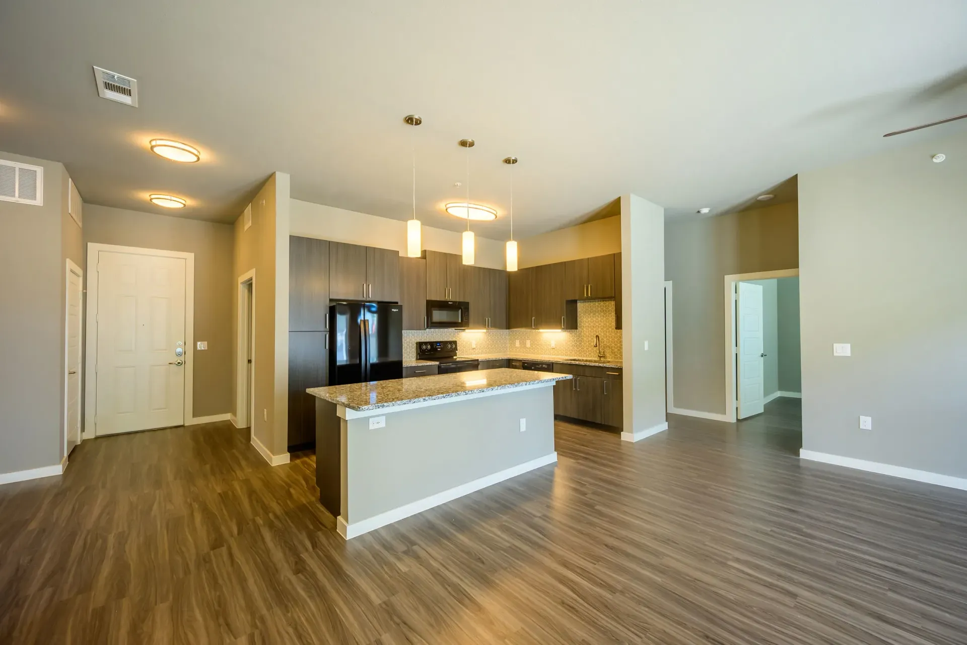 Kitchen and living area at Harmony Luxury Apartments in Rowlett, TX.