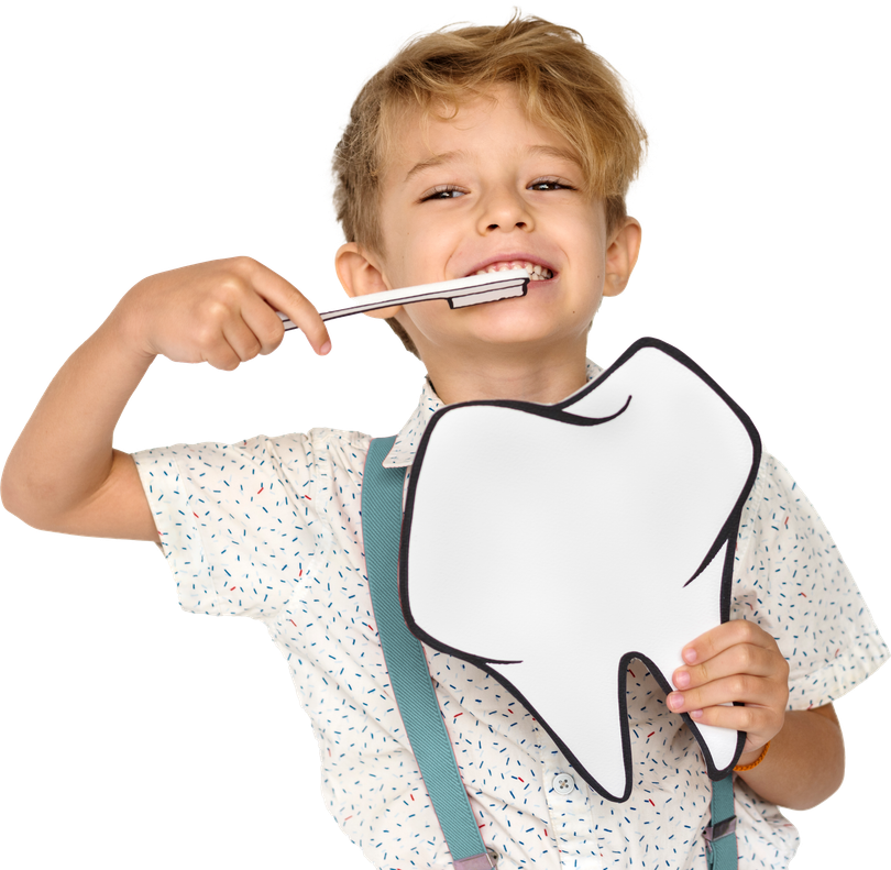 A young boy is brushing his teeth while holding a paper tooth.