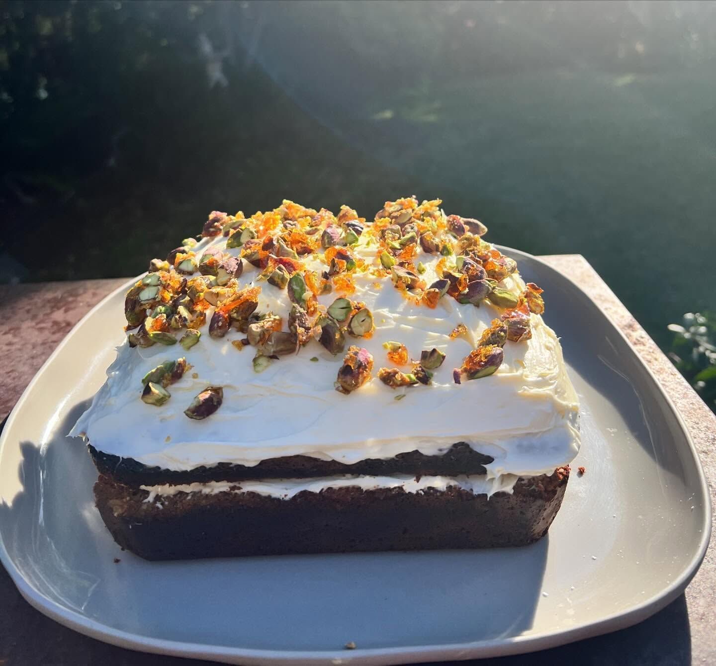 A Slice of Cake With Pistachios on Top on a Plate — Coastal Catering in North Avoca, NSW