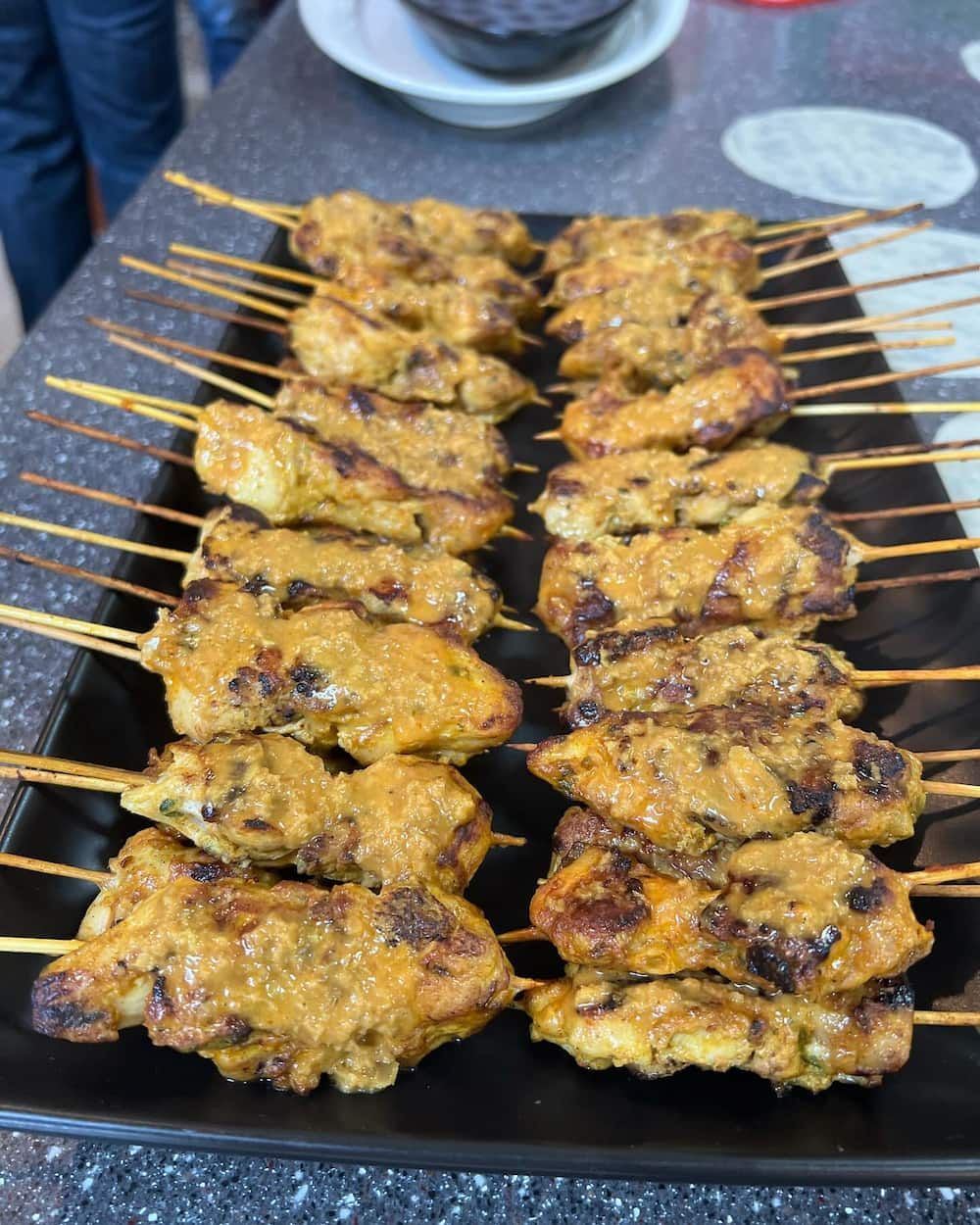 A Tray of Chicken Skewers With Sauce on Them — Coastal Catering in North Avoca, NSW