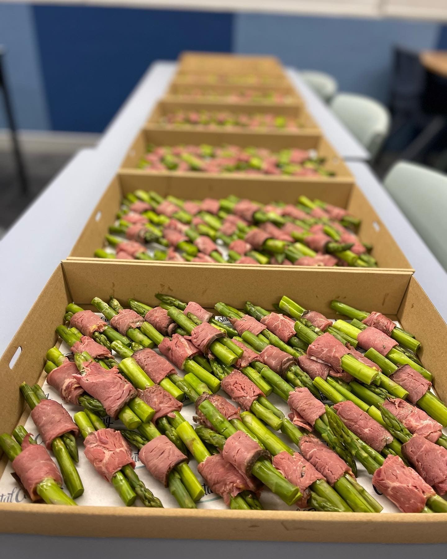 Boxes of catered food containing meat wrapped around vegetables — Coastal Catering in North Avoca, NSW