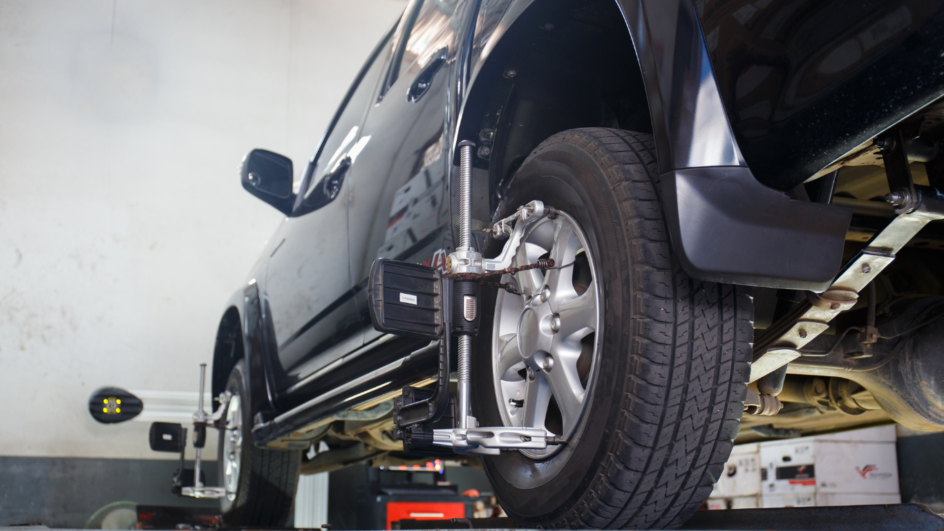 A car is being aligned in a garage.