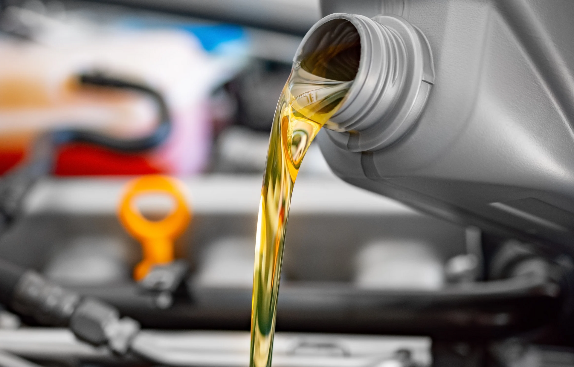 A close up of the engine of a car with the hood open.