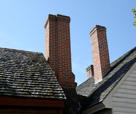Two brick chimneys on the roof of a house