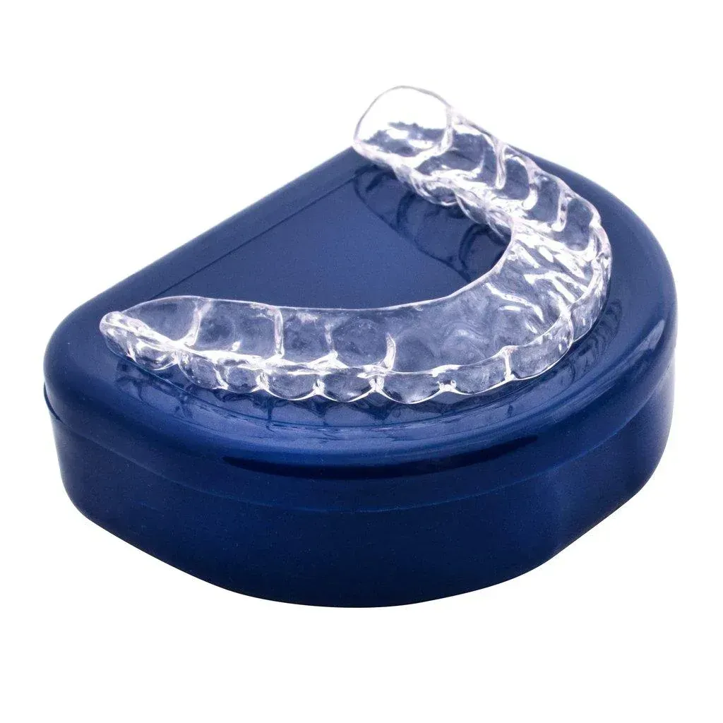 A clear dental aligner or retainer resting on top of a closed blue plastic storage case.
